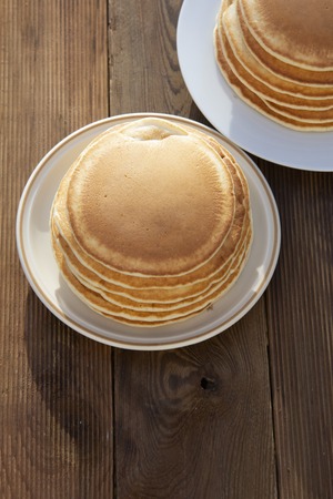 Pancakes. Stack of isolated american pancakes over wooden table. breakfast,の写真素材