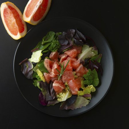 Healthy salad grapefruit and green leaves. Deliciouse dietary food. lose weigh. Salad in black plate.の写真素材