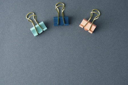 Colorul binder clips isolated on grey background, work space, work table,