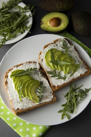 Avocado sandwich toast bread made with fresh sliced avocado, cream cheese. healthy food concept. Food. Breakfast or snack.の写真素材
