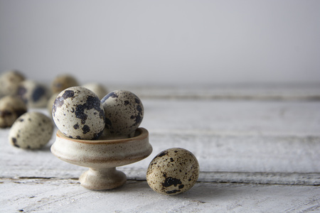 Quail eggs over white wooden background. Isolated quail raw eggs. rustic style. Healthy food...