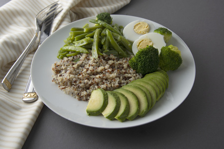 Green detox food. Salad bowl with quinoa and green vegetables - green peas, avocado, broccoli and eggs.の写真素材