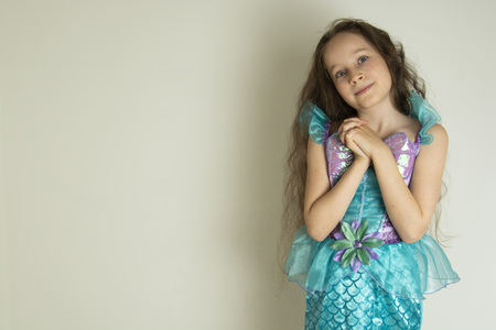 Corby, United Kingdom. March 12, 2019. Little girl with long hair, dressed as mermaid. Little Mermaid cosplay costume. Disney movie character. Copy space.のeditorial素材