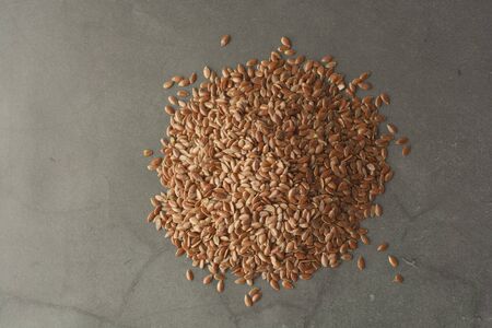 Linen. Flax seeds. Dark background. Healthy food concept Top viewの写真素材