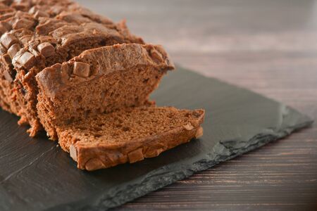 Chocolate cake. Pound cake with chocolate chips, wooden board.