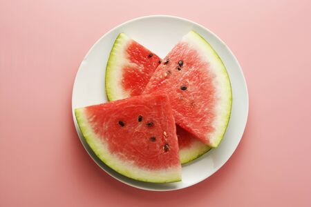 Watermelon slices in plate isolated onpink background. Summer foods.の写真素材