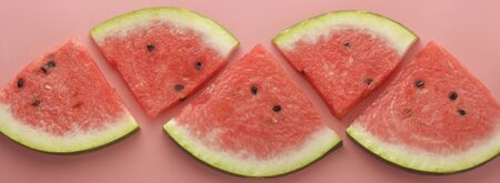 Watermelon slices over pink background. Summer foods. Web banner.