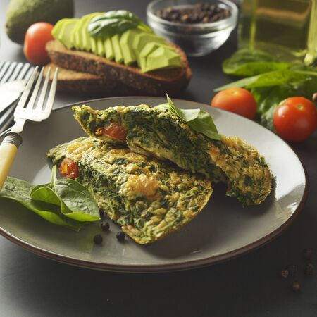 Omelet with spinach leaves. Healthy omelette for lose weight. Healthy food. Breakfast. Square image.の写真素材