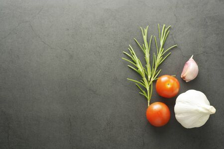 Rosemary and cherry tomatoes. Dark background, mock up for pasta, menu, Italian food, food blogging.の写真素材