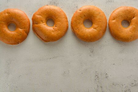 Bagels isolated on bright and textured board. Copy space.の写真素材