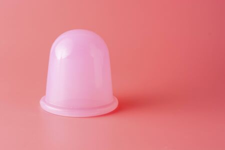 Silicone massage for body, silicone vacuum massage cap over pink background, copy space.の写真素材