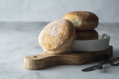 Delicious sugar donuts on a white plate, pastry for breakfast or desert.の写真素材