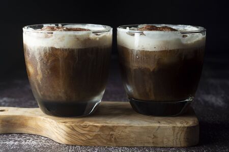 Affogato coffee with ice cream on a glass cup. Caffeine drink. Dark background.