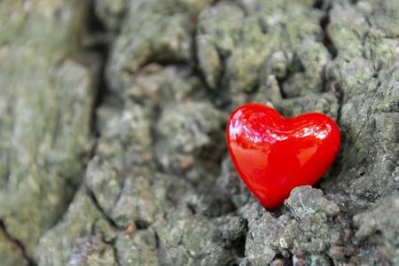 Two red hearts on old gray textured wooden background with copy space for text, vertical image