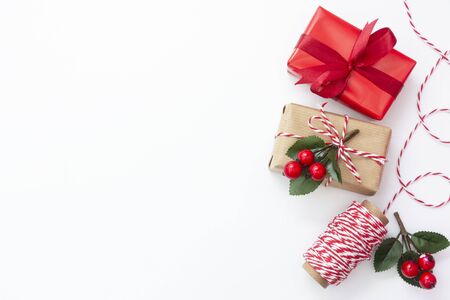 Christmas background. Gift boxes wraped in craft paper over white background. Wraping gift boxes. Top view. Copy space or text.の写真素材