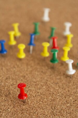 Pins on a wooden notice board