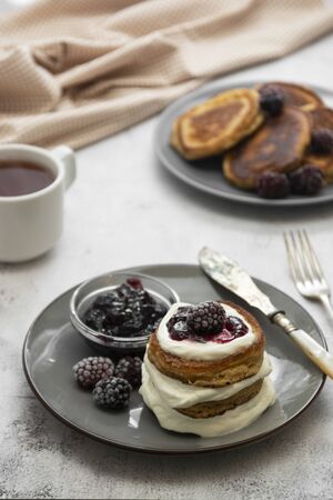 Pancakes with berry and jam. homemade, vegan pancakes with cream and fruit jam.の写真素材