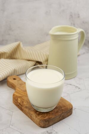 Jug and glass with milk on bright background isolated. Breakfastの写真素材