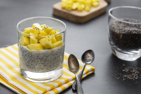 Coconut Chia seed pudding with pineapple, dark background copy space. Healthy food concept.の写真素材