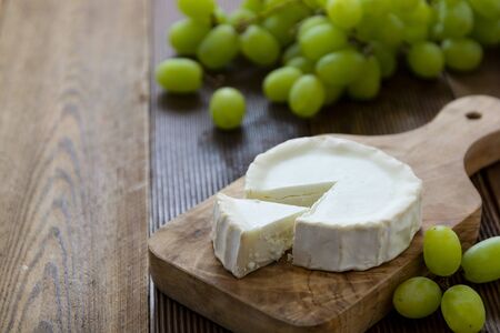 Goat cheeses on wooden background isolated.Dark food photo.の写真素材