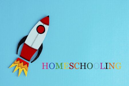 Homeschooling text with rocket over blue abstract background. Learn from home. Quarantine education.の写真素材