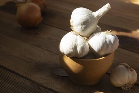 Isolated garlic whole on wooden background. Cooking ingredientsの写真素材