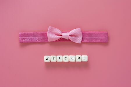 Welcome for baby girl, pink background with head band and bow. Baby girl background.の写真素材