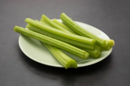 Detox food. Fresh celery sticks on gray background.の写真素材