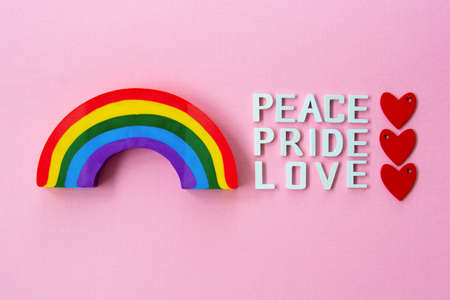 Words peace, love, pride over pink background with rainbow. LGBT gay pride concept.の写真素材