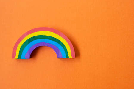 Rainbow object, over orange background. LGBT concept. Education background with copy space.の写真素材