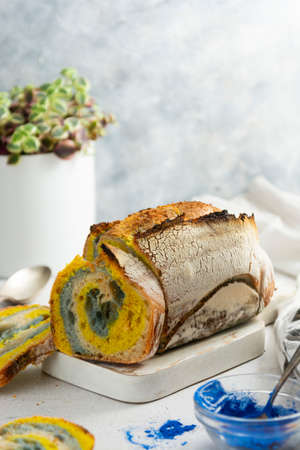Sourdough bread loaf with turmeric and blue spirulina powders. Homemade healthy bread.の写真素材