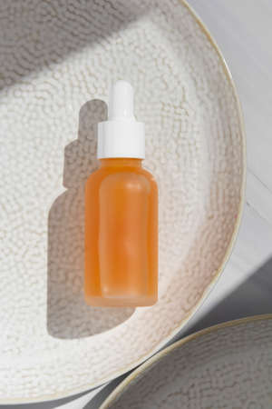 Essence oil, vitamin c serum, beauty cosmetics, aroma therapy. Natural shades, pink backgroundの写真素材