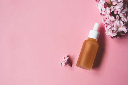 Essence oil orange mate pipette bottle, vitamin c serum, beauty cosmetics, aroma therapy. Pink backgroundの写真素材