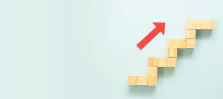 Business growth concept abstract blue background. Red arrow wooden stairs. Bannerの写真素材