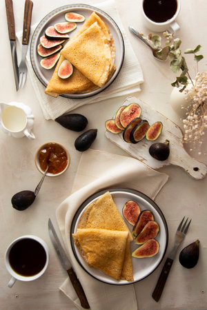 Crepes, thin pancakes with honey on a white plate. Marble background. Top view.の写真素材