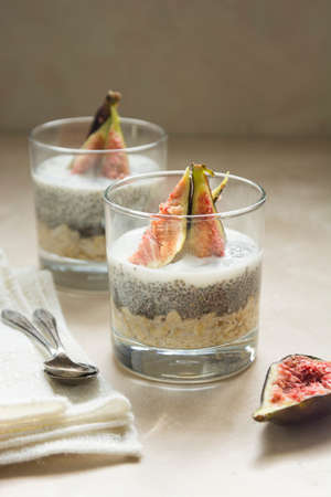Chia seed pudding breakfast glass portions with freh figs and plant based milk. Healthy food.の写真素材