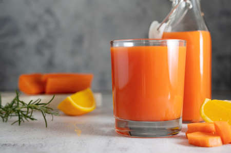 Orange and carrot juice or fruit smoothie. Healthy food, detox concept.の写真素材