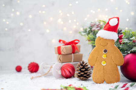 Gingerbread man cookie with santa hat, on bright background with bokeh lights. Christmas background....