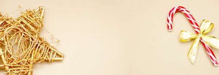 Christmas banner minimalistic, golden star and candy cane with bow, winter decorations, copy space...