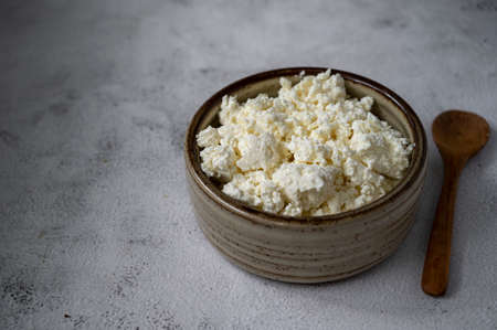 Cottage cheese in rustic bowl, healthy food dairy product conceptの写真素材