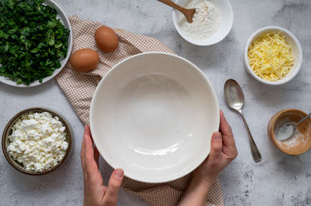 Cooking spinach quiche healthy homemade tart with spinach and cheese. Step by step recipe. Top view.の写真素材