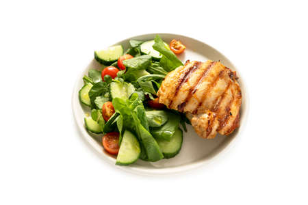 Healthy food, low carb diet. Grilled chicken meat and fresh salad in a plate, isolated on a white backgroundの写真素材