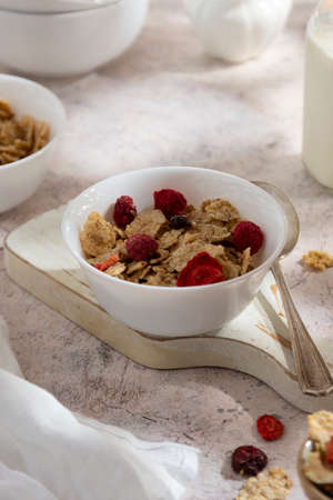 Corn flakes with strawberry and blueberry in bowls over backgroundの写真素材