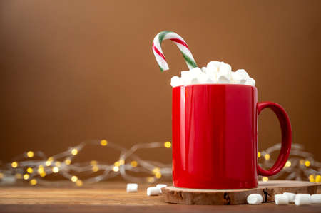 Hot chocolate or warm winter drink in red mug with marshmallows. Christmas concept.の写真素材