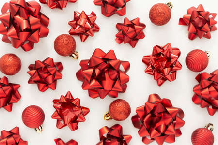 Abstract Christmas background with red ribbons and sparkling baubles.の写真素材