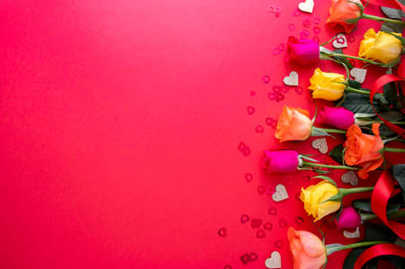 Roses flowers on red background with glitter and hearts, Love flat lay abstract Valentine's Day,...