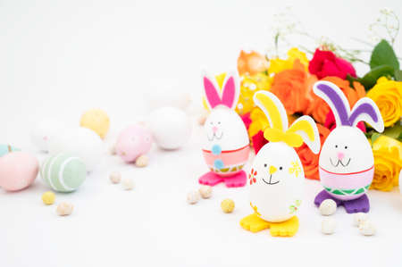 Easter bunny eggs with colorful flowers on background. Abstract Easter greeting cardの写真素材