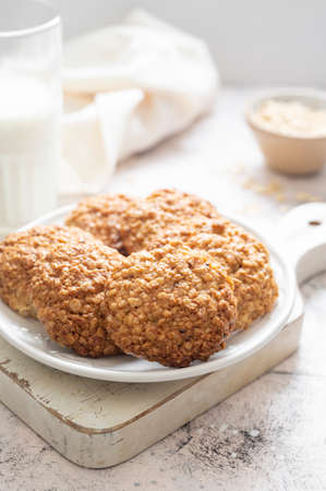 Close up homemade oat cookies, healthy snack on bright backgroundの写真素材