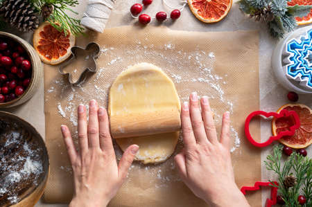 Cooking Christmas cookies. Hands and rolling pin. Step by step recipe. Top view.