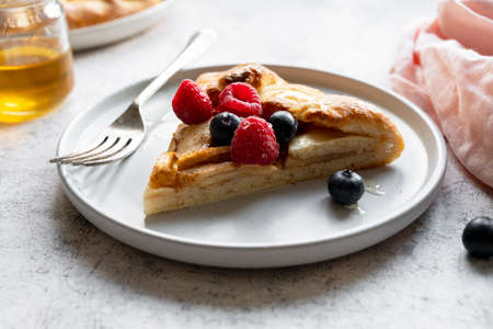 Apple tart or galette with cinnamon and fresh berries. Home bakingの写真素材